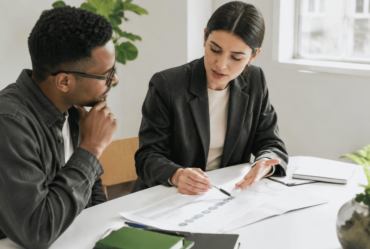 A specialist walking a client through a process on paper