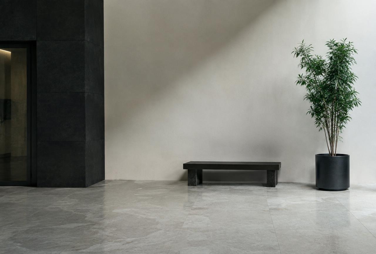 A calm, quiet stone lobby with a bench and a plant